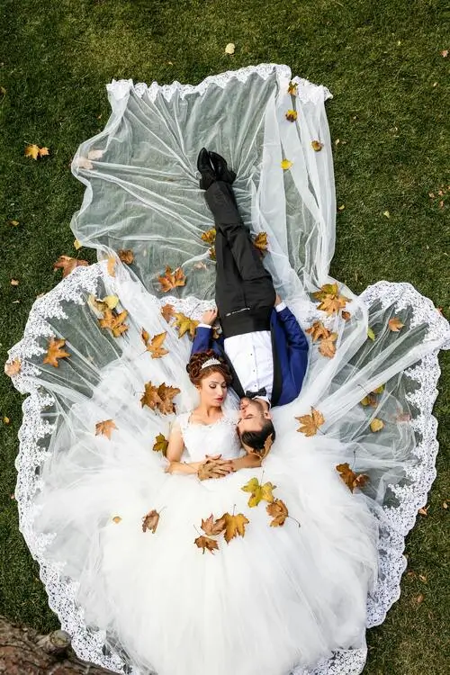Married couple laying on grass